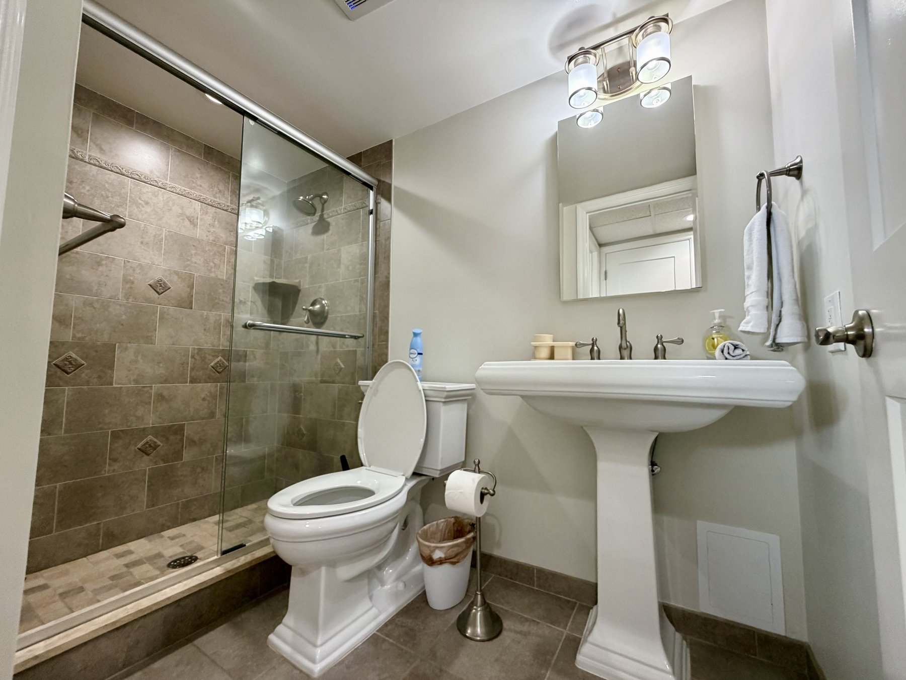 Guest bathroom walk-in shower in rental unit 1003