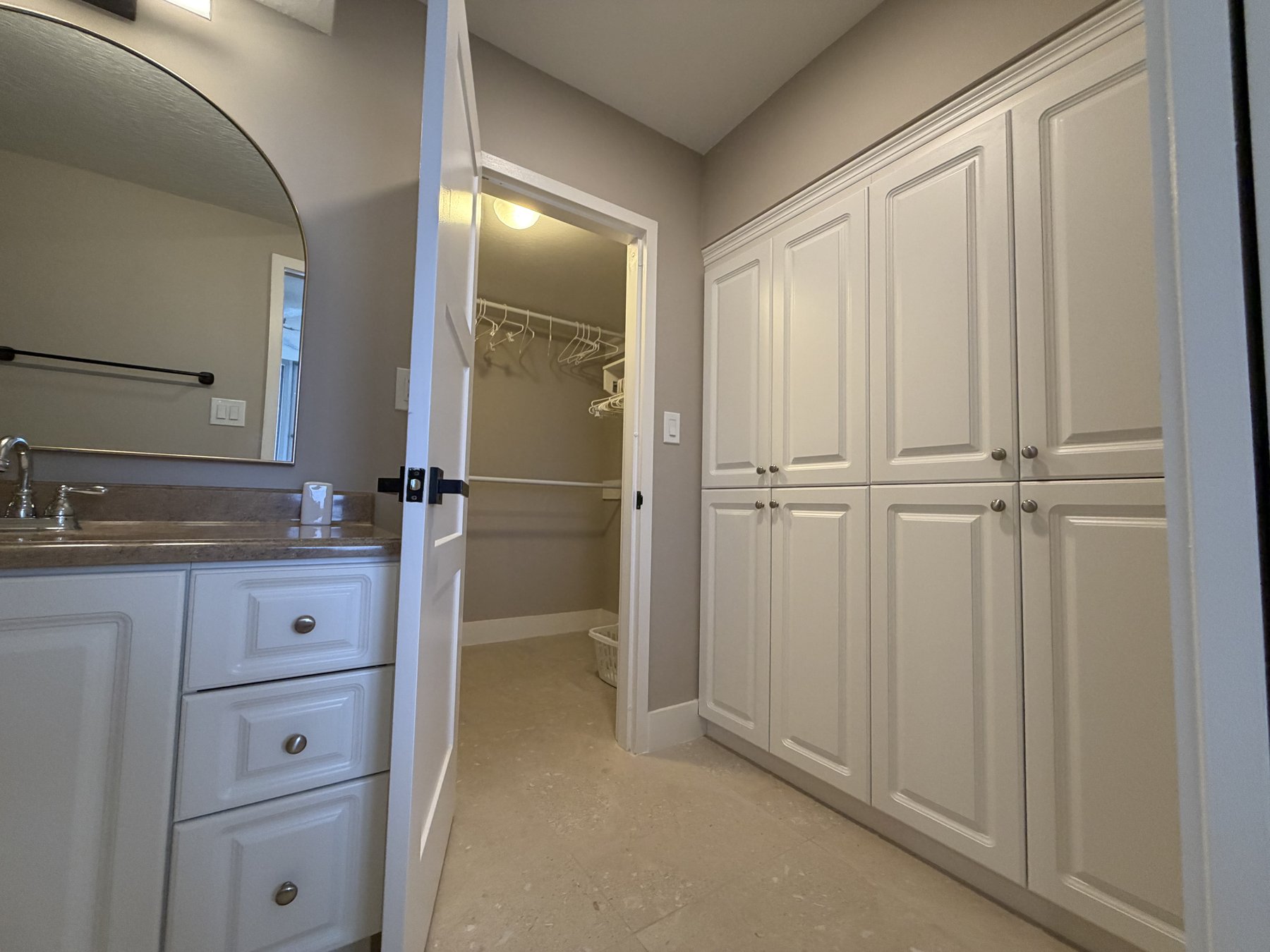 Primary bedroom dressing area and closet in rental unit 205