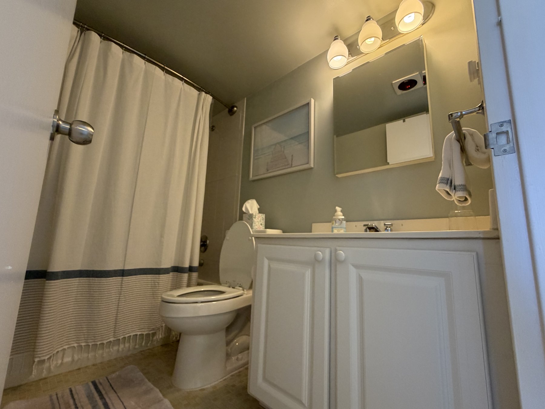 Primary bathroom with tub and shower in rental unit 601